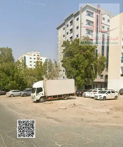 For sale in Ajman, residential/commercial land in Al Rashidiya 3, 6400 sq ft, permit G+10, corner plot with two streets and an alley. Asking 2.7M