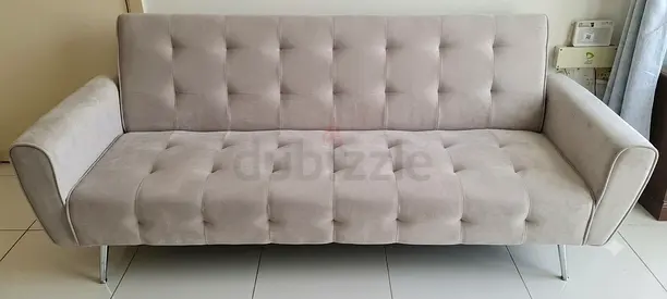 Light grey tufted 3-seater sofa bed with chrome legs