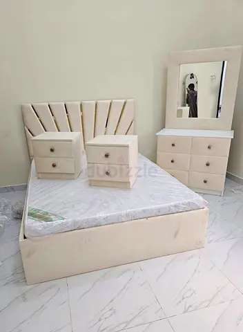 Cream upholstered double bed with mattress, 2 bedside tables and dresser with mirror