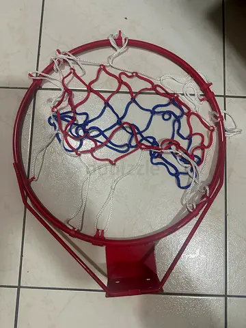 Used metal basketball hoop rim with red, white and blue net
