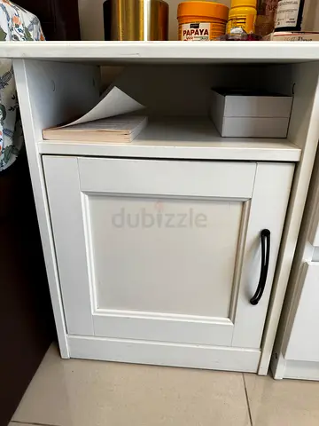 Small white bedside cabinet with storage compartment