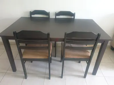 Simple dark wood dining table with 4 chairs - good condition..Negotiable