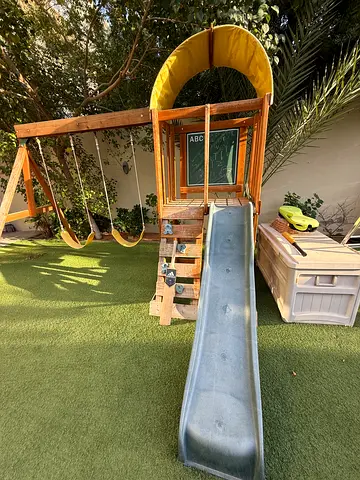 Wooden kids swing set with slide and climbing features - good condition