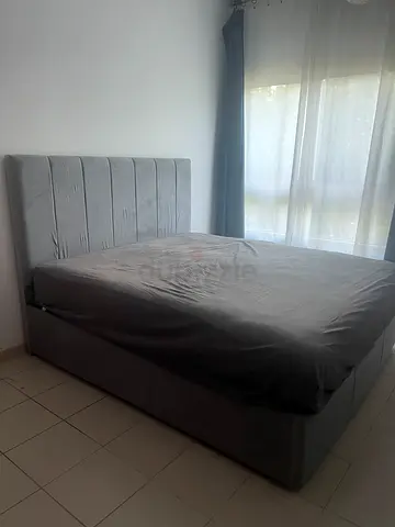Queen size upholstered grey bed frame with headboard