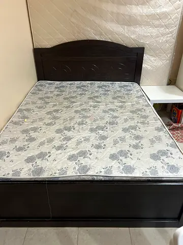 Queen bed frame with used mattress - dark wood