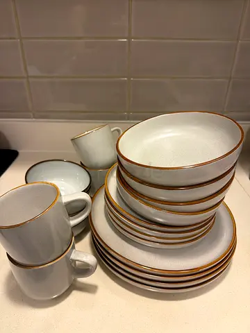 Used 20-piece stoneware dinner set with gold rim - good condition