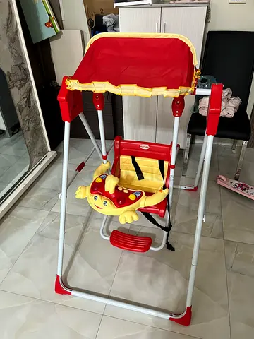 Red and yellow baby swing with canopy - good condition