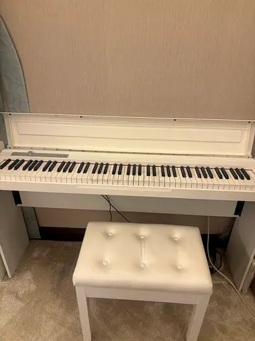White digital piano with bench - compact upright style, excellent condition