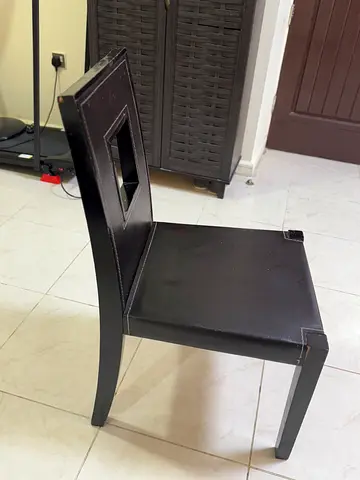Four Chair Dining Table. Black faux-leather dining chair with square Table.