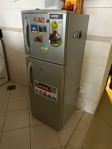 Silver double-door refrigerator in good working condition