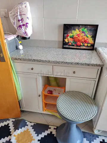 Compact white kitchen island / storage cabinet with granite top