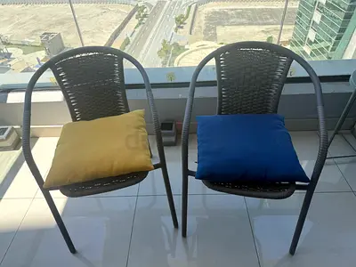 Set of 2 rattan-style patio chairs with cushions