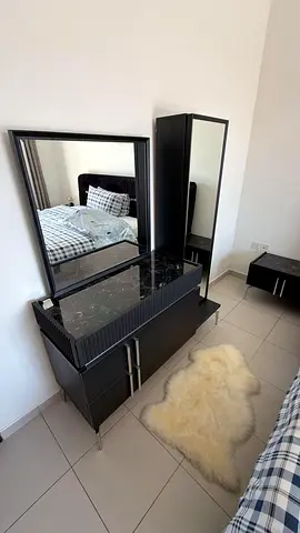 Black bedroom vanity dresser with mirror and tall mirrored cabinet with mattress rarely used