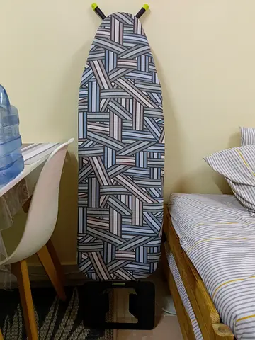 Sturdy ironing board with patterned cover - good condition