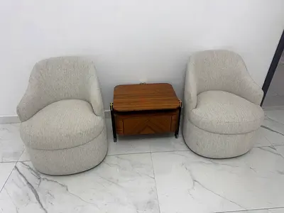 Pair of Modern Beige Swivel Lounge Chairs with Small Wooden Side Table