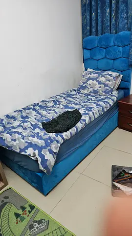 Single upholstered bed with tufted headboard