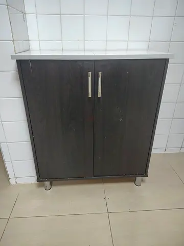 Compact two-door storage cabinet with white top - good condition