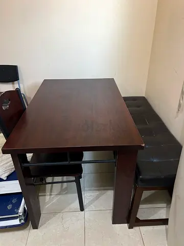 Solid dark wood dining table with bench seating - good condition