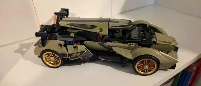 Used green LEGO-style Technic sports car model - partially assembled