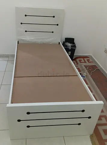 Single white wooden bed frame with headboard