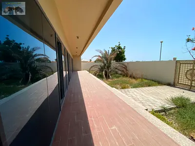 Commercial villa for rent in Al Zorah with five master bedrooms, majlis, living room, central AC, maid room, laundry room, yard and covered parking.