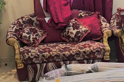 Used 2-seater floral upholstered sofa with cushions - good condition