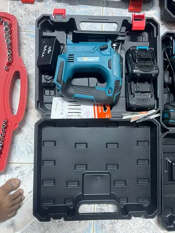 Used cordless jigsaw with 2 batteries and case and other tools