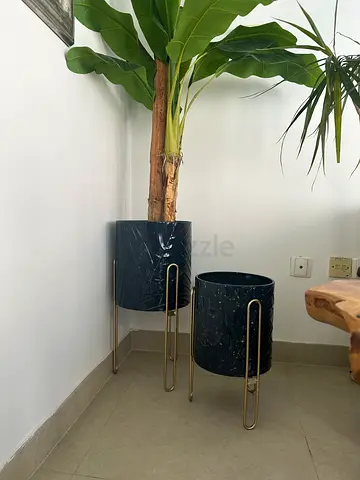 Two blue Marina Home plant pots with gold stands for indoor decoration
