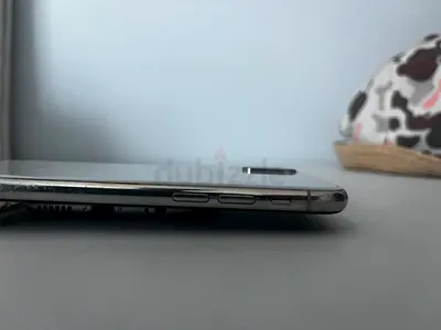 Used Apple iPhone X with visible side buttons and SIM tray - good condition