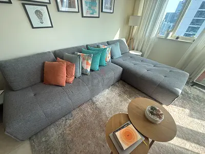 Light grey L-shaped fabric sofa with chaise, good condition