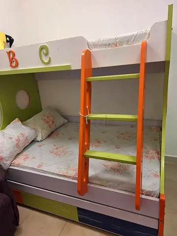 Kids bunk bed with ladder and floral mattress - good condition