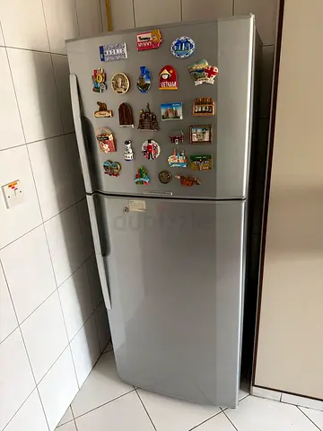 Silver double-door refrigerator in good working condition (stainless finish)