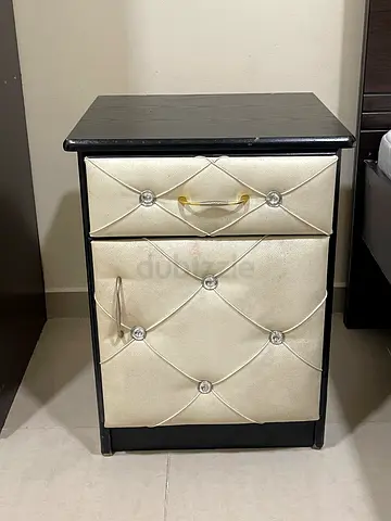 Small two-drawer bedside table with tufted faux-leather fronts