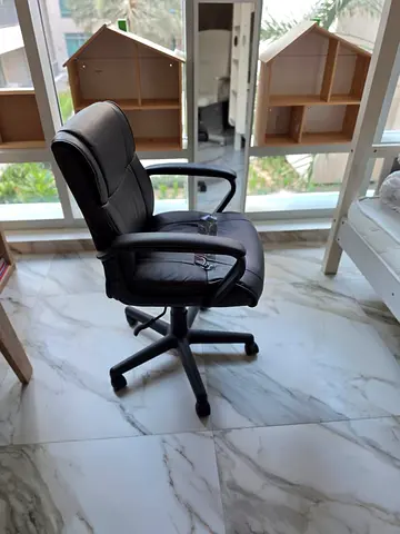 Black ergonomic office chair with armrests —