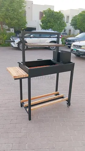 Portable charcoal BBQ grill cart with rotisserie and side shelf