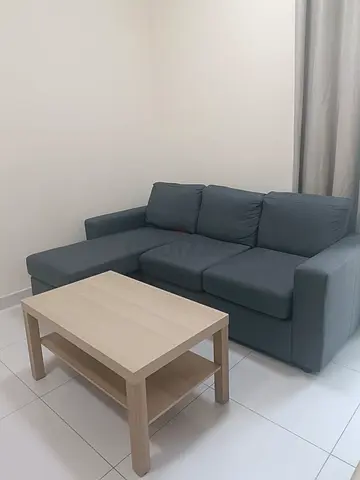 Two-seater L-shaped sofa with chaise and sofa table in grey - good condition