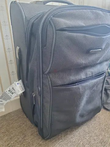 Used black travel suitcase with multiple compartments