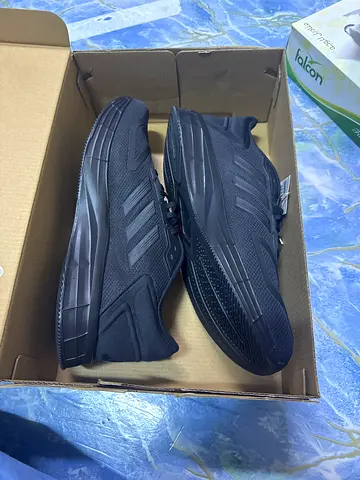 Pair of black Adidas running shoes - size available