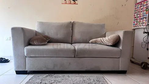 Two-seater light grey fabric sofa in good condition