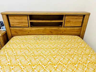 Oak-effect king size bed with built-in headboard shelves