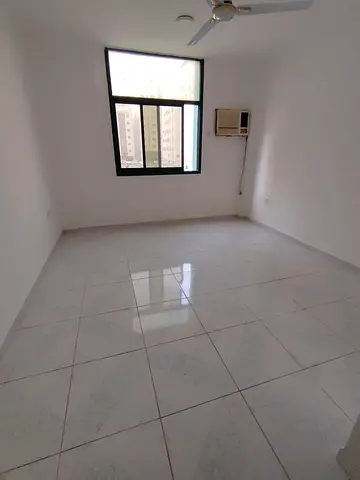Spacious studio for annual rent in Al Qasimia Al Mahatta, Sharjah. AED 17000 yearly, 4 or 6 payments, semi separate kitchen, postdated cheque.