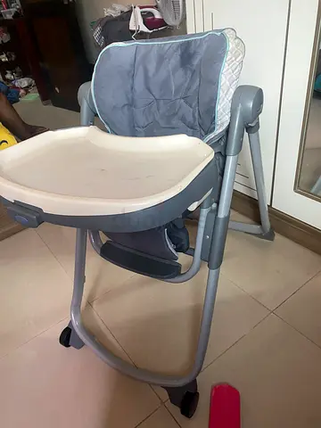 Practical grey baby high chair with adjustable tray - good condition