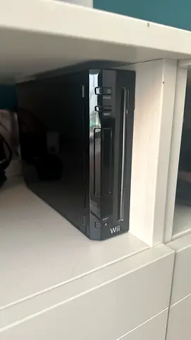 Black Nintendo Wii console and wii board in good working condition