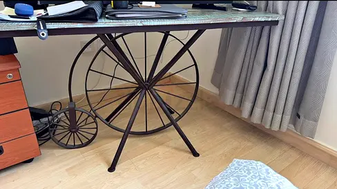 Industrial-style metal wheel base side table with marble top