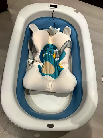 Baby bathtub with padded infant support cushion and mini washing machine