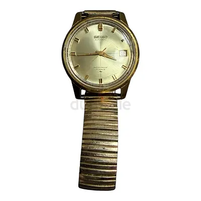 Seiko Sportsmatic 7625-8043 from the 1960s featuring a gold-toned case and a silver sunburst dial.