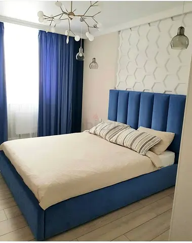 Blue upholstered double bed with padded headboard - modern frame