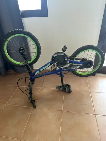 Blue kids mountain bike with green rims - good condition