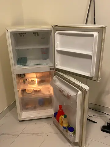 Compact white double-door refrigerator with freezer - used, working