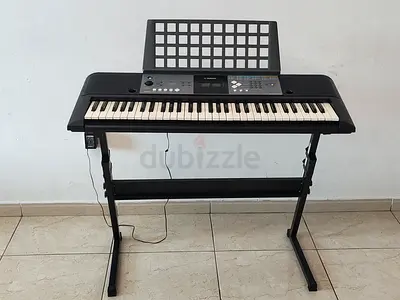 Yamaha electronic keyboard with stand, charger, and dustproof cover - well maintained